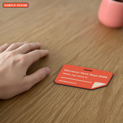 Custom 3D printed event badge holder in coral beside a hand for scale, sample design for a made-up event