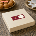 Custom sweet box label, 100 x 50 mm festive Diwali kaju katli label for Kesar Kona Sweets on a cream sweet box lid, sample design for a made-up sweet shop