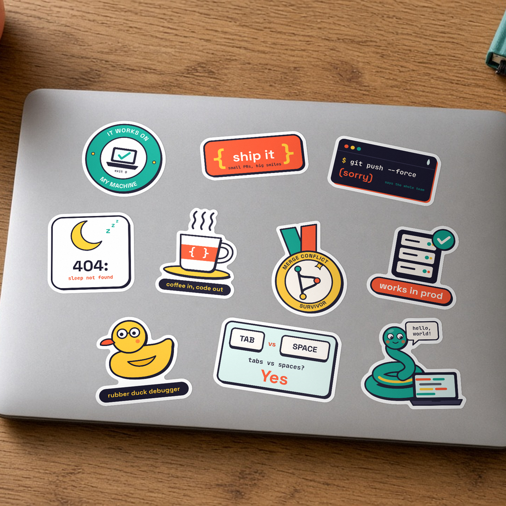 Desk Buddy Bundle: the ten Dev Life stickers, including Works in prod and Rubber duck debugger, on a silver laptop lid.