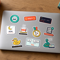 Dev Life Sticker Pack: all ten dev stickers, including It works on my machine, Works in prod and Rubber duck debugger, on a silver laptop lid.