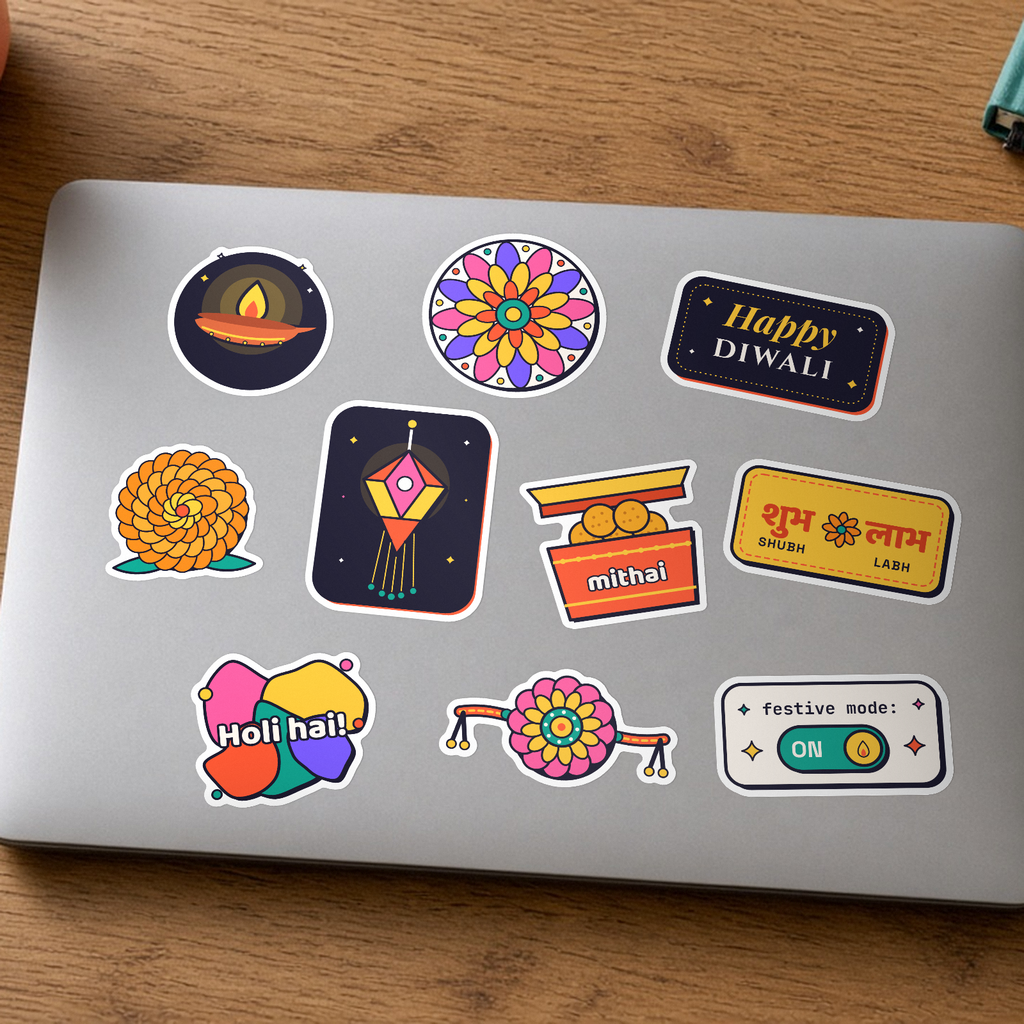 Festive Sticker Pack: all ten festival stickers, including a diya, rangoli, Happy Diwali, Shubh Labh and a rakhi, on a silver laptop lid.