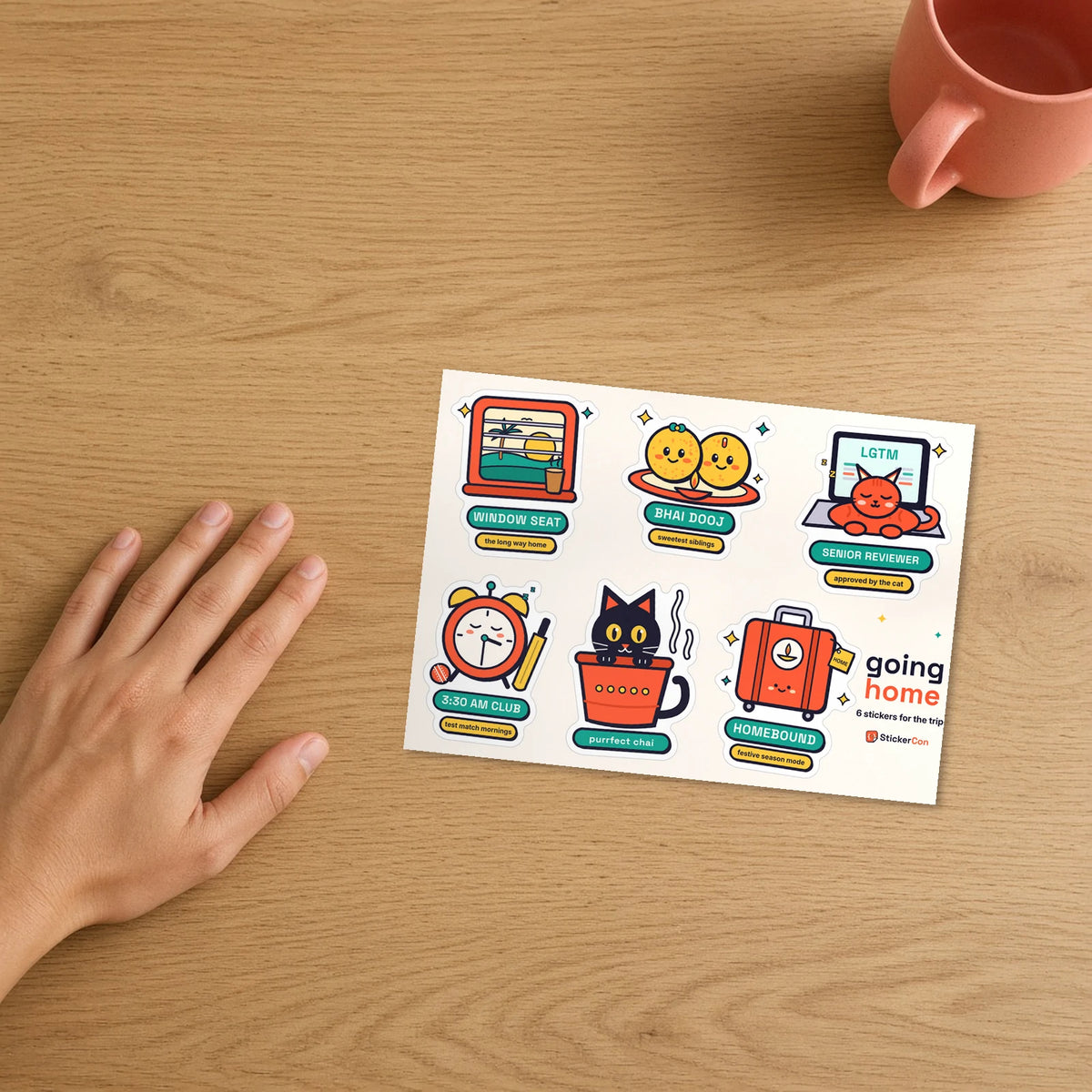 Going Home Sticker Pack 5 x 7 inch kiss-cut sheet on a desk beside a hand for scale
