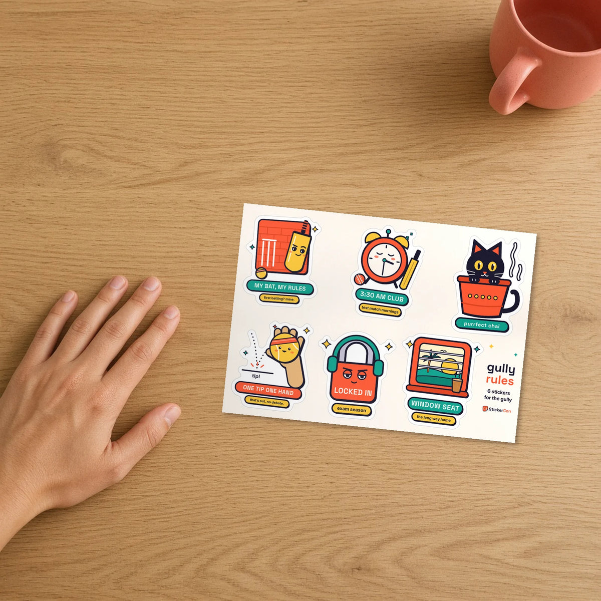 Gully Rules Sticker Pack 5 x 7 inch kiss-cut vinyl sheet on a desk beside a hand for scale