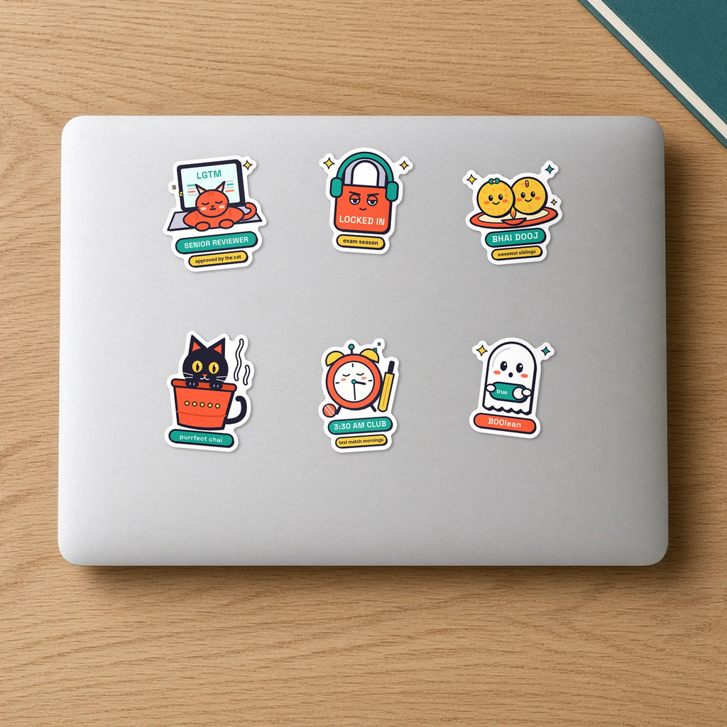 New Drops Sticker Pack: six die-cut vinyl stickers on a laptop lid, including Kulhad Cat, Locked In, BOOlean Ghost, 3:30 AM Club, Senior Reviewer and Laddoo Siblings