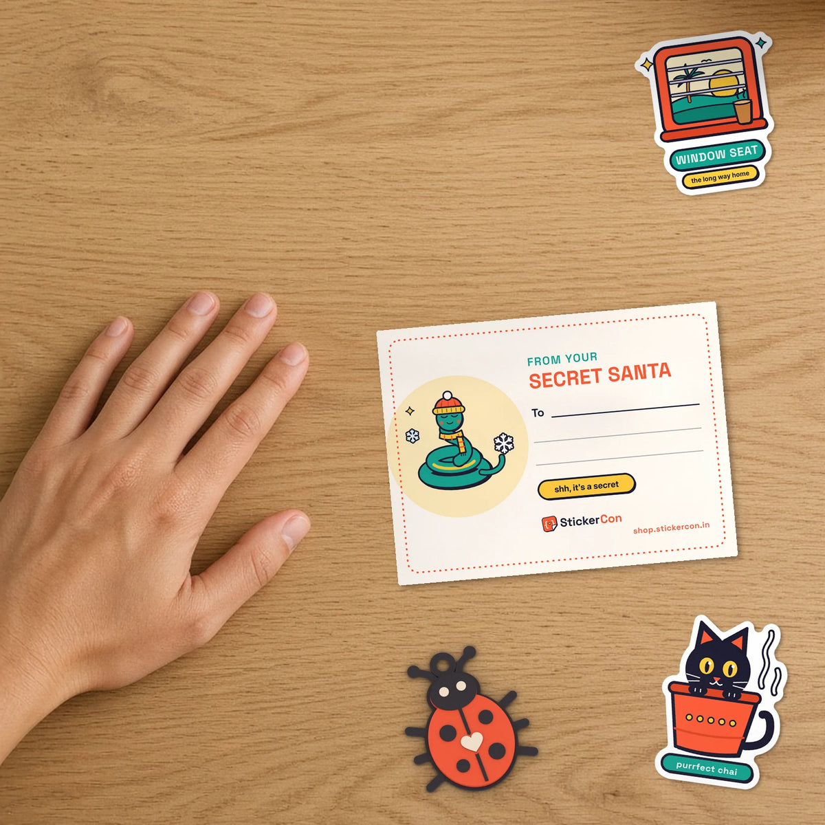 Close-up of the Secret Santa desk calendar back with From your Secret Santa note, keychain and stickers