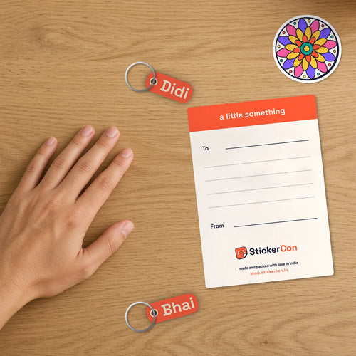 Close-up of the Bhai Dooj Sibling Set card back with To and From note and the two sample name keychains