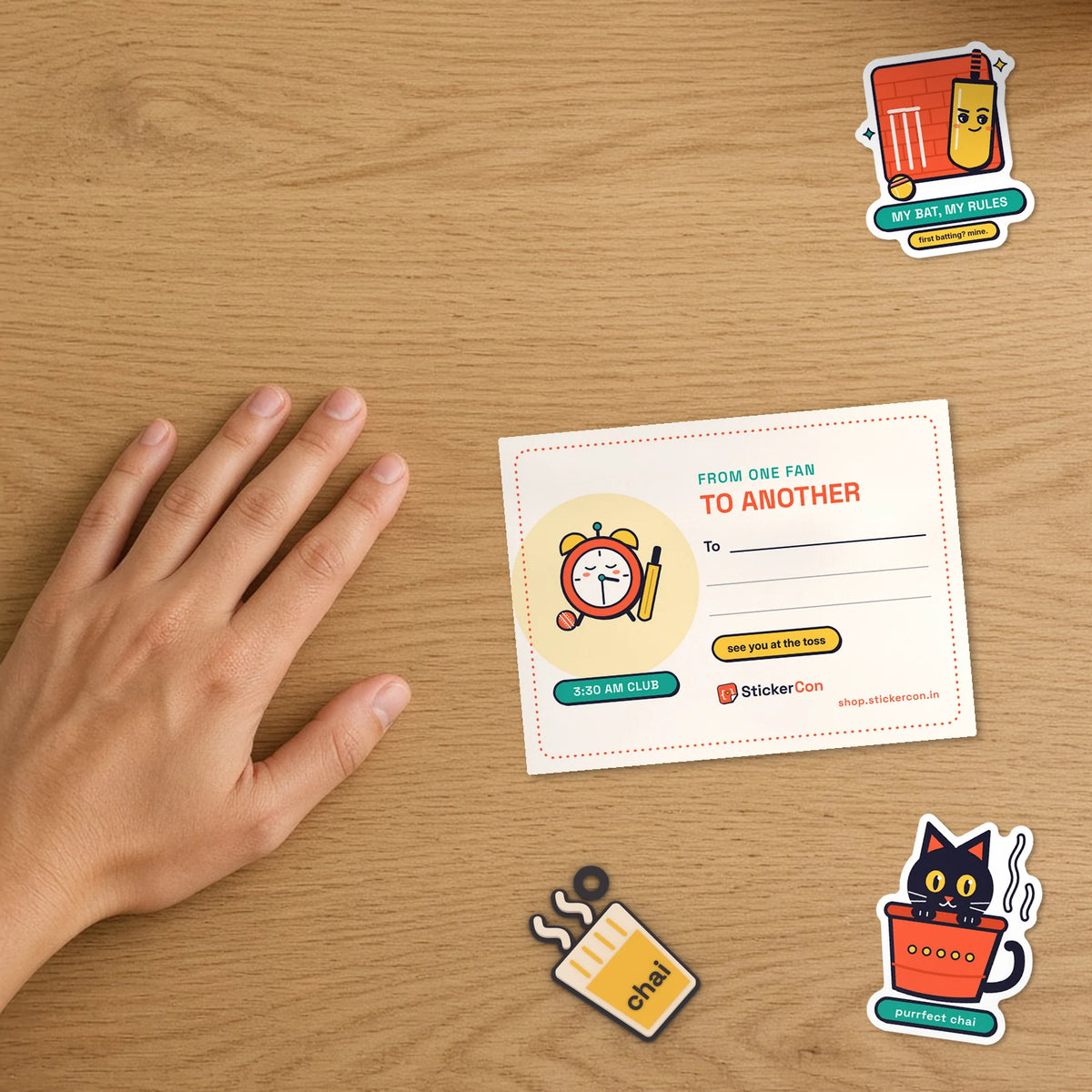 Close-up of the Test Match Night card back showing From One Fan to Another gift note with chai keychain and stickers